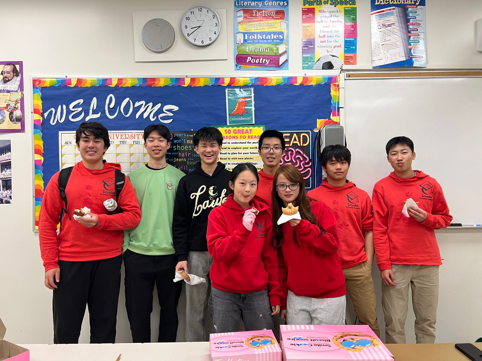 Scuola team members standing together in a classroom.