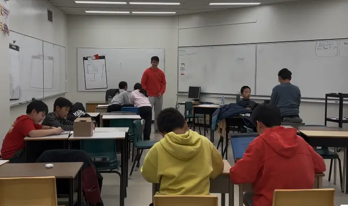 Students seated in a classroom during a Scuola debate session.